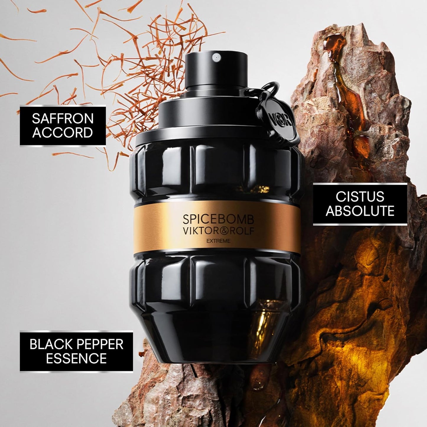 Viktor & Rolf Spicebomb perfume bottle with saffron, cistus absolute, and black pepper essence text on a textured background.